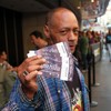 An Andrea Bocelli fan displays his tickets for the Central Park Concert